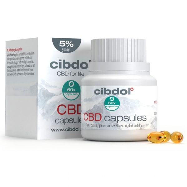 eine flasche cbd-kapseln neben einer schachtel cbd-kapseln.
