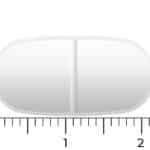 Neben einem Lineal ist eine weiße ovale Vitakruid - Magnesium 200 Complex® (90 Tabletten)-Tablette mit einer Bruchkerbe abgebildet, die etwa 2 cm lang und 1 cm breit ist.